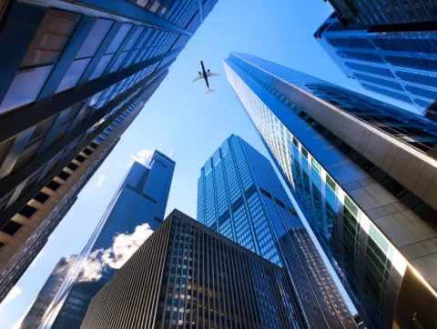 Skyscrapers and airplane depicting travel industry landscape